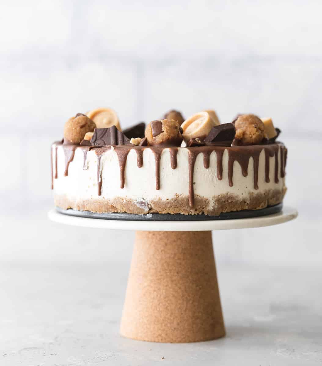 cookie cheesecake on a cake stand.