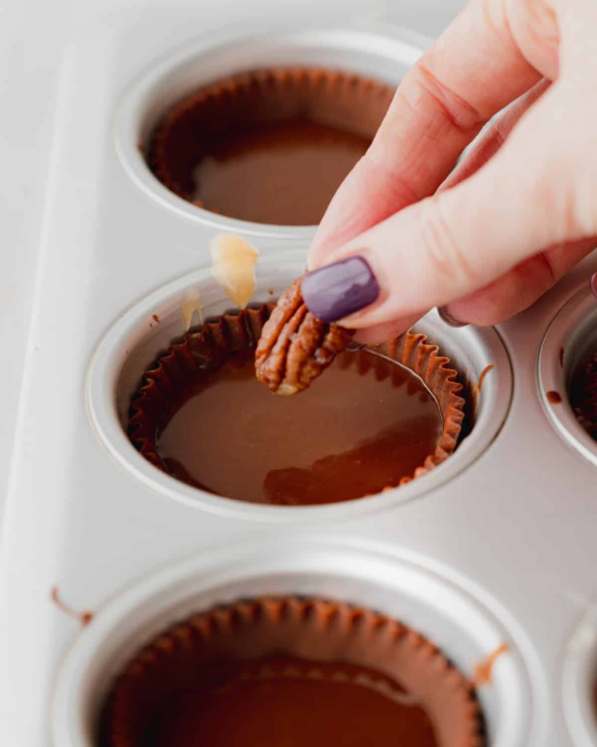 making chocolate cups with pecans.