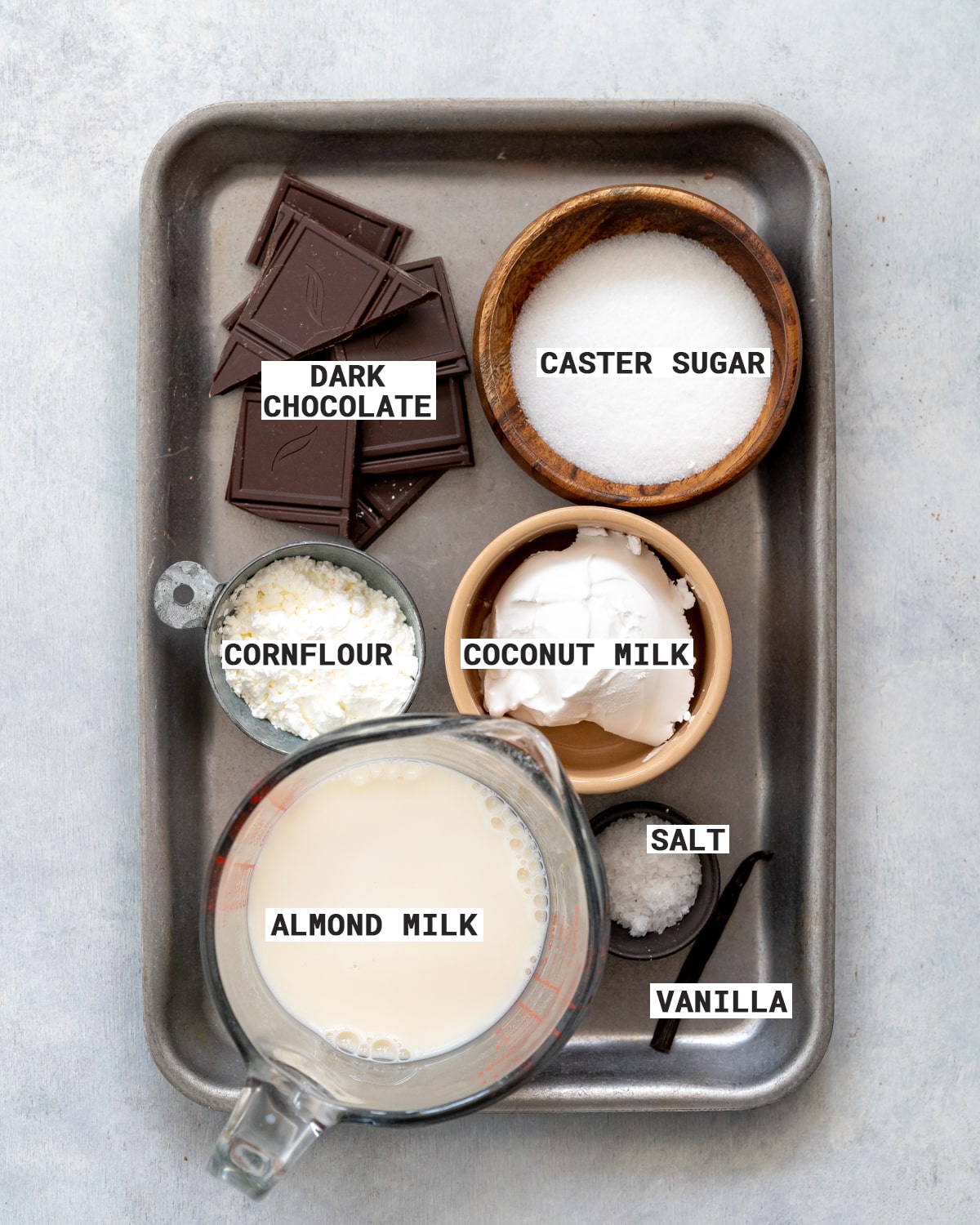 ingredients to make dairy free chocolate pastry cream on a metal tray.
