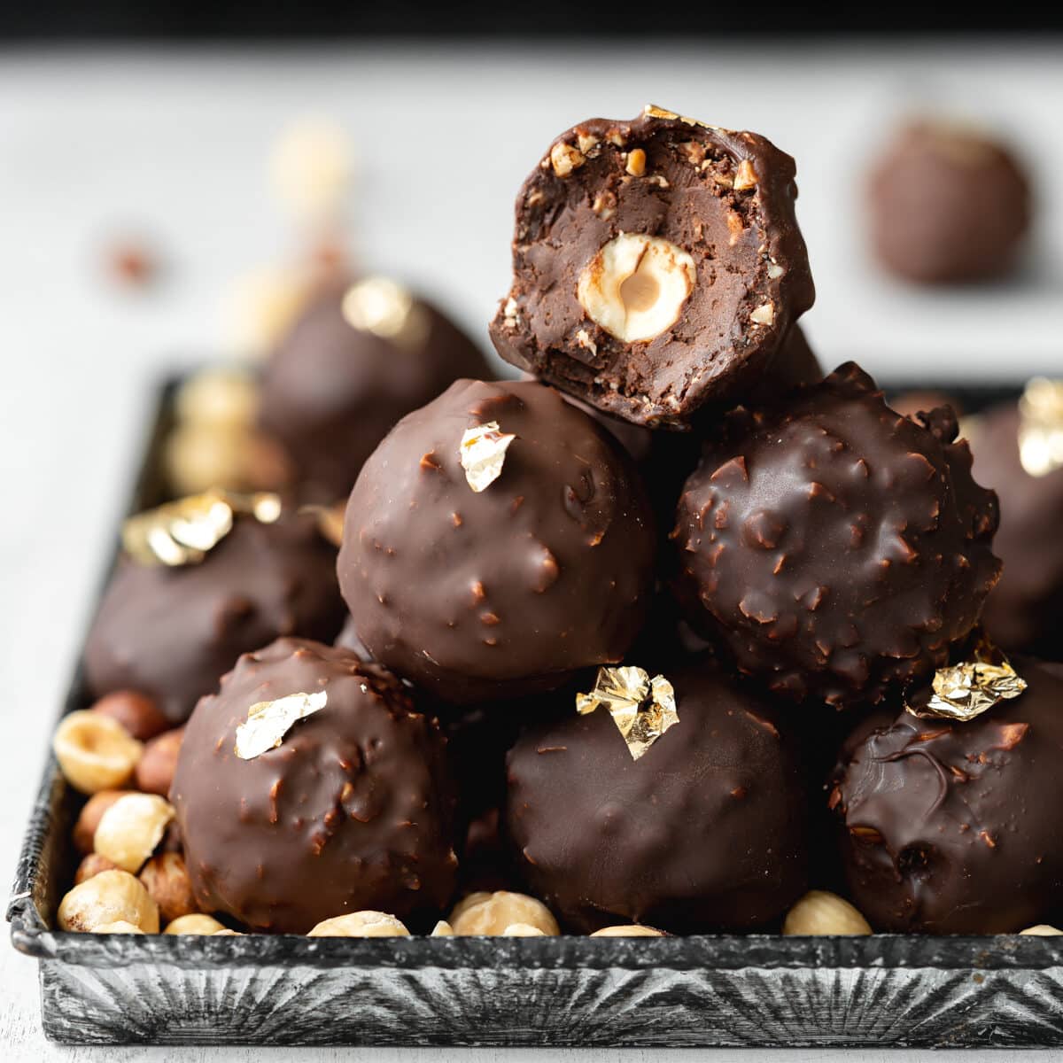 stack of homemade ferrero rocher truffles with gold leaf.