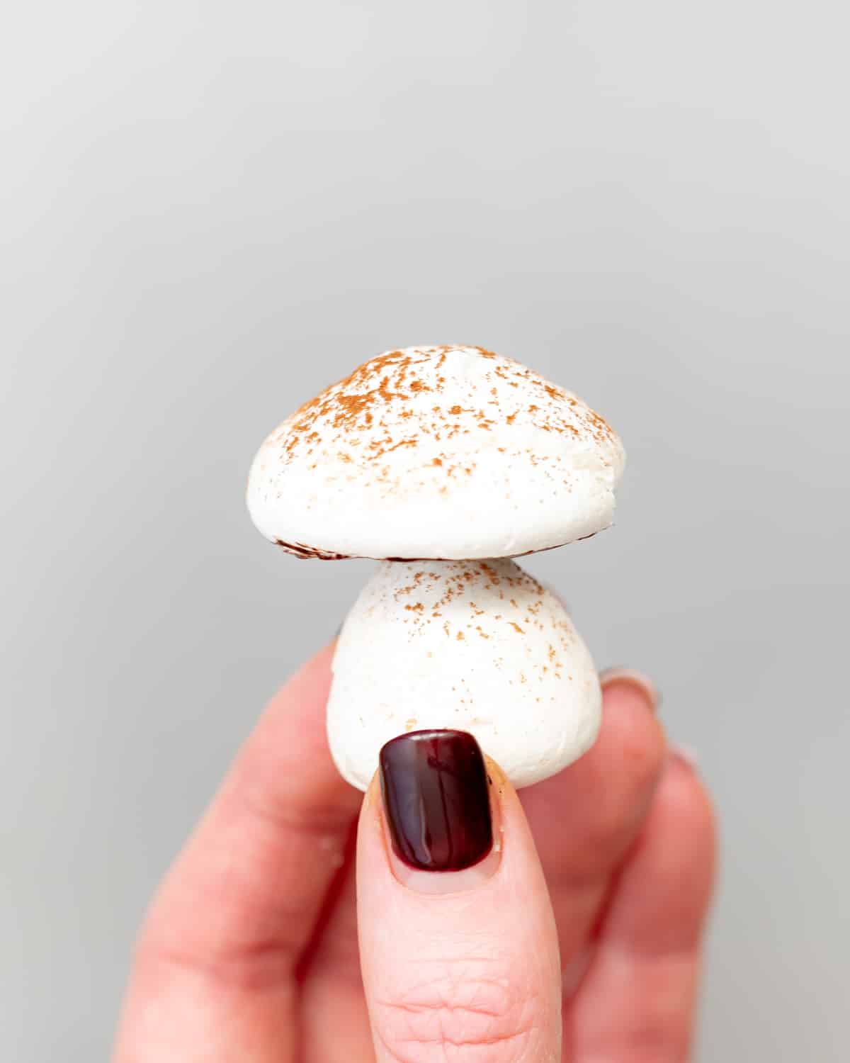 hand holding a aquafaba meringue mushroom.